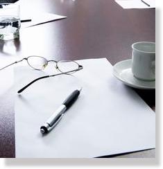 pen and glasses on table